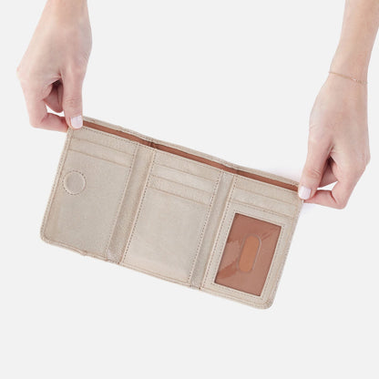 Jill Trifold Wallet In Metallic Leather - Sand Shimmer | HOBO