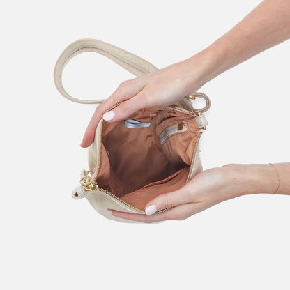 Sway Small Sling In Metallic Leather - Sand Shimmer | HOBO
